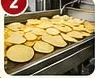 Thinly sliced potatoes on production line